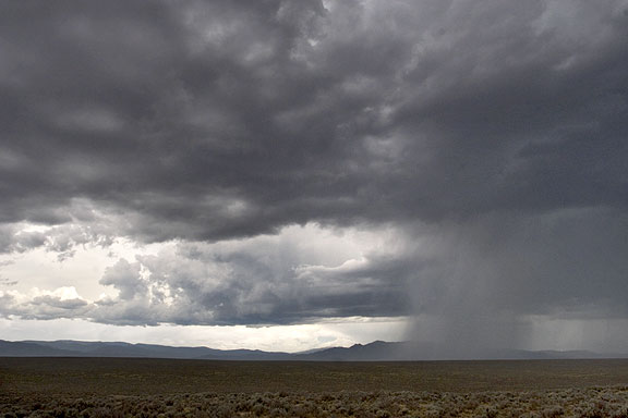 This image is of a column of rain which settled in over Pilar NM and washed out a smal bridge some culverts and a road.