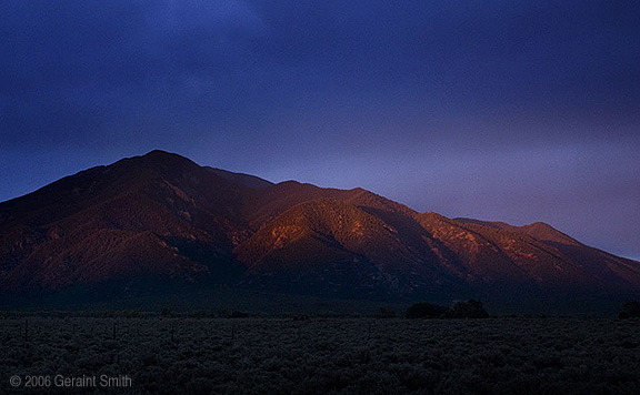 Taos Mountain with a brief glimmer of sunlight before sunset