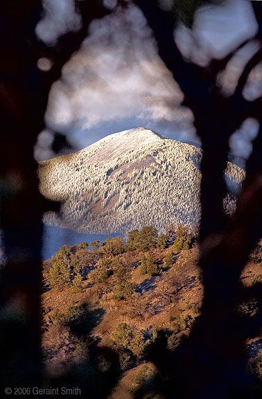 Trees with a view, A window in the trees and a light dusting of snow on Taos mountain