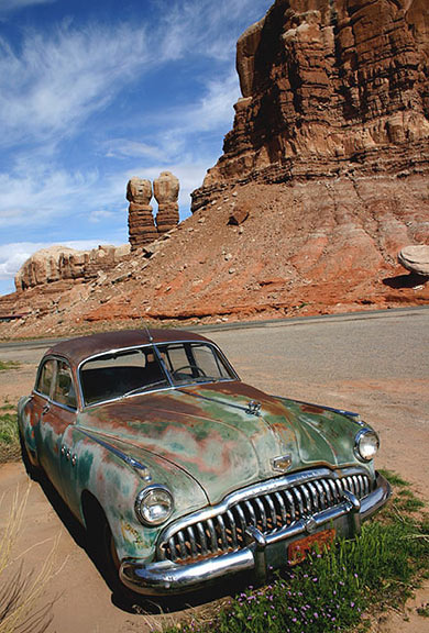 Old Buick in Bluff Utah at the Cow Canyon Trading Post Twin Rocks in the background