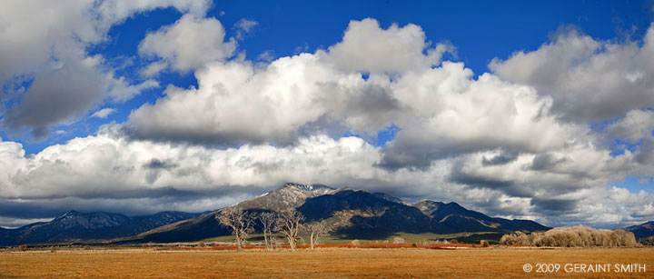 Big clouds, blue skies, Taos Mountain and new snow