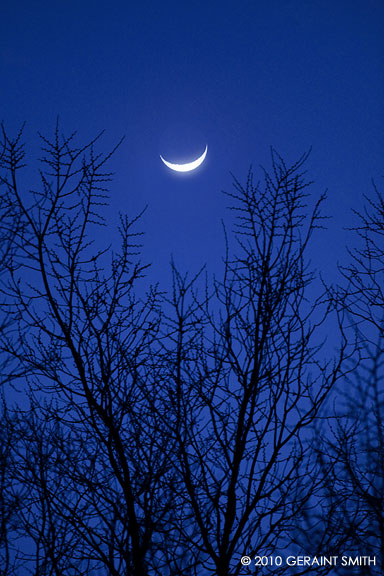 Cradled crescent moon over Taos, NM