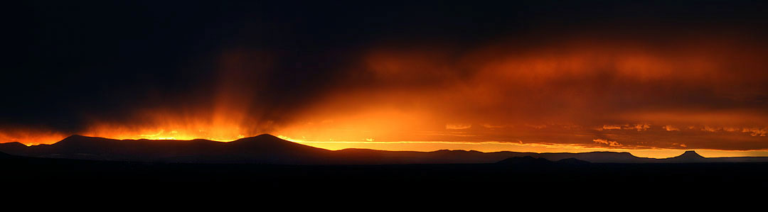 A Taos winter sunset with the Jemez mountains and Cerro Pedernal (the flat top on the right)