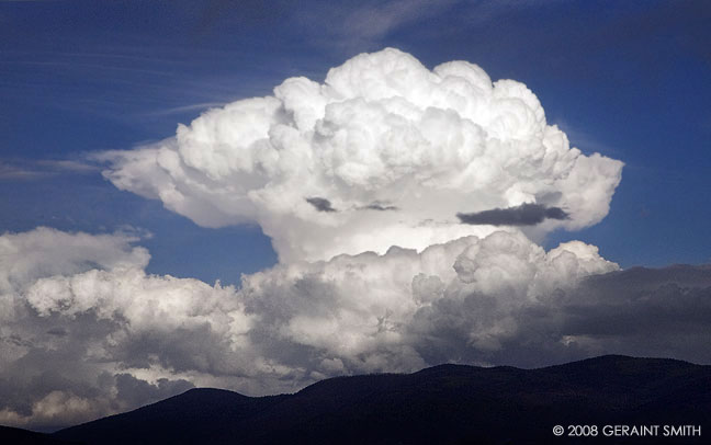 Anvil head thunder storm cloud building over Taos