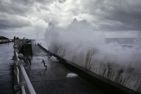 High tide at Porthcawl in South Wales, UK,  A scene from my childhood. 40 years ago I was the one dashing for cover under the boardwalk