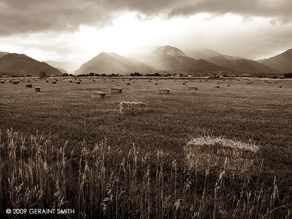 Bales in the fields and wintery skies over Arroyo Seco, New Mexico
