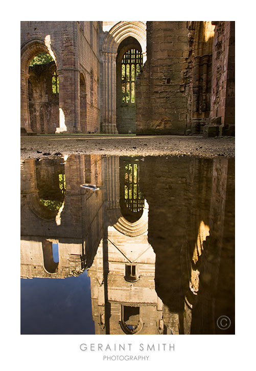 Reflections in a rain puddle in Fountains Abbey, Yorkshire