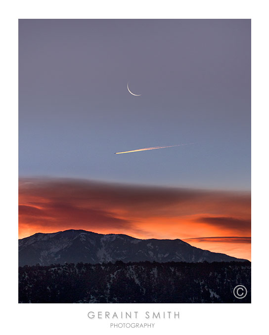 This morning's sunrise, moonrise and travelers over Taos Mountain as seen from San Cristobal