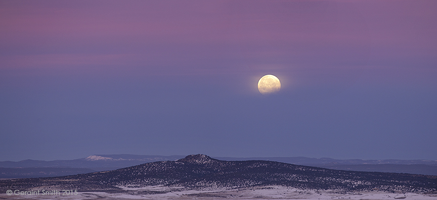 Full moon setting across the Taos Vocanic Plateau, new mexico