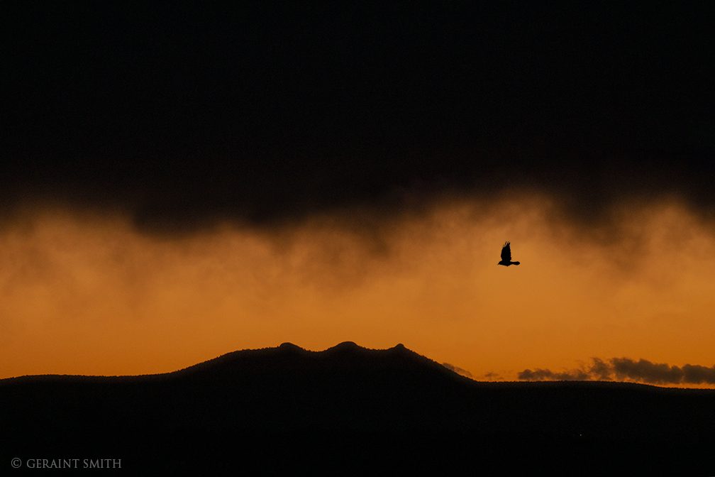 Raven flight with Three Peaks, also known as Tres Orejas, and the sunset