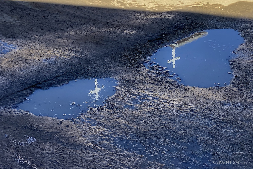 Crosses reflecting in a puddle